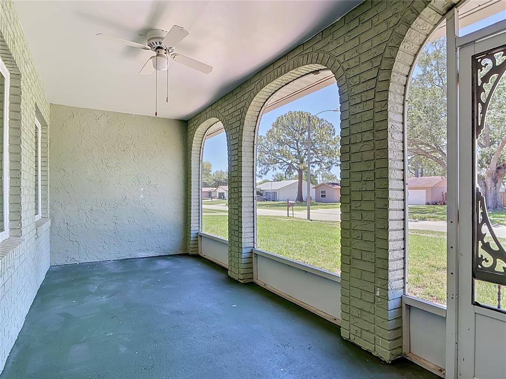 A swimming pool with a screen enclosure sits on a concrete patio behind a house — 1237 JEFFERY DRIVE, PORT ORANGE, FL