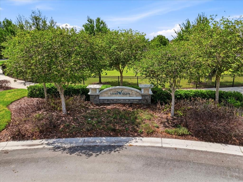 A large outdoor swimming pool with a paved deck and lounge chairs — 6431 COMO PLACE, LAKELAND, FL