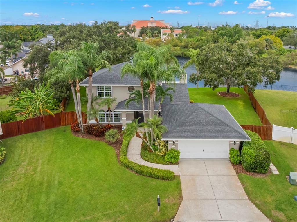 An aerial view of a suburban house with a pool and lake in the backyard — 1747 87TH TERRACE N, ST PETERSBURG, FL