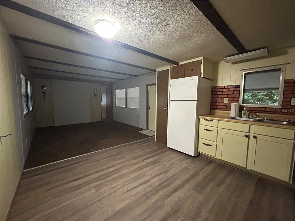 A small, white fiberglass shower stall with a gray curtain and two bottles of soap — 9640 SE 161ST PLACE, SUMMERFIELD, FL