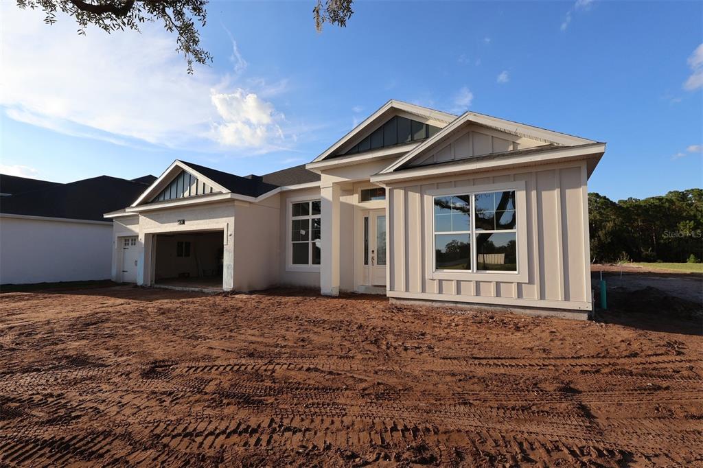 An exterior view of a house under construction featuring concrete block walls and roof framing — 3011 SOLACE WAY, ORLANDO, FL