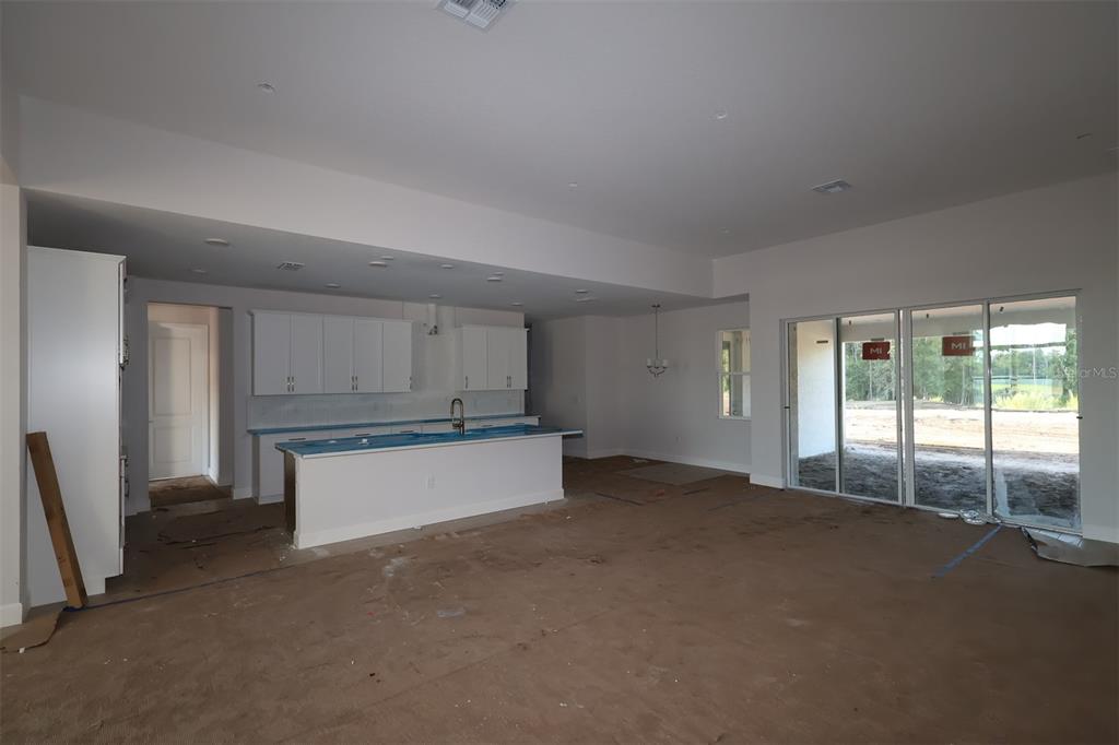 An interior view of a house under construction showing exposed wooden wall studs and trusses — 3011 SOLACE WAY, ORLANDO, FL