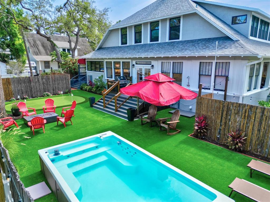 A single-story house with a large front porch, a dormer window, and a paved walkway — 1523 1ST AVENUE W, BRADENTON, FL