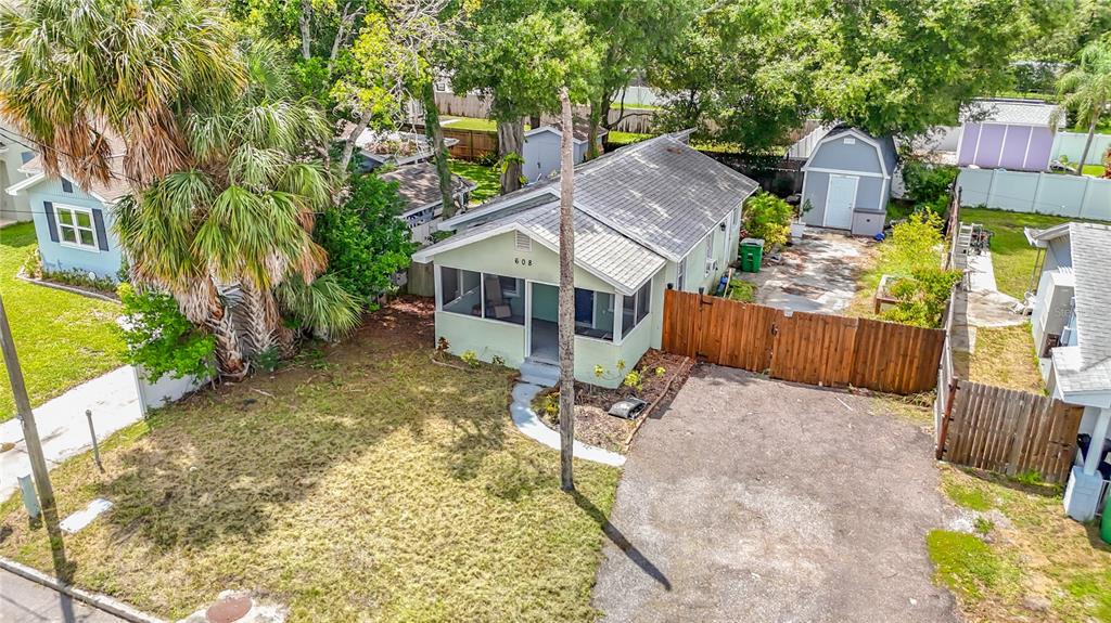 An aerial view of a single-story house with a front porch, driveway, and backyard shed — 608 N LINCOLN AVENUE, TAMPA, FL