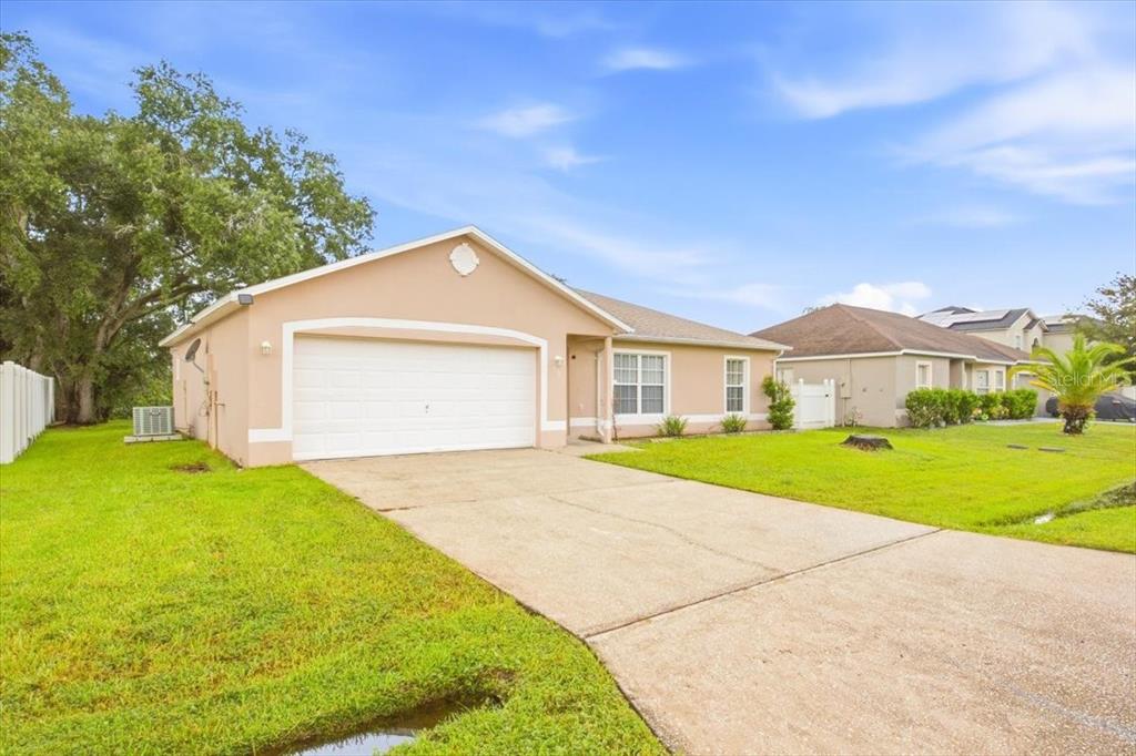 An empty room features glossy orange tile flooring, white walls, and a sliding glass door — 718 PINCON LANE, KISSIMMEE, FL