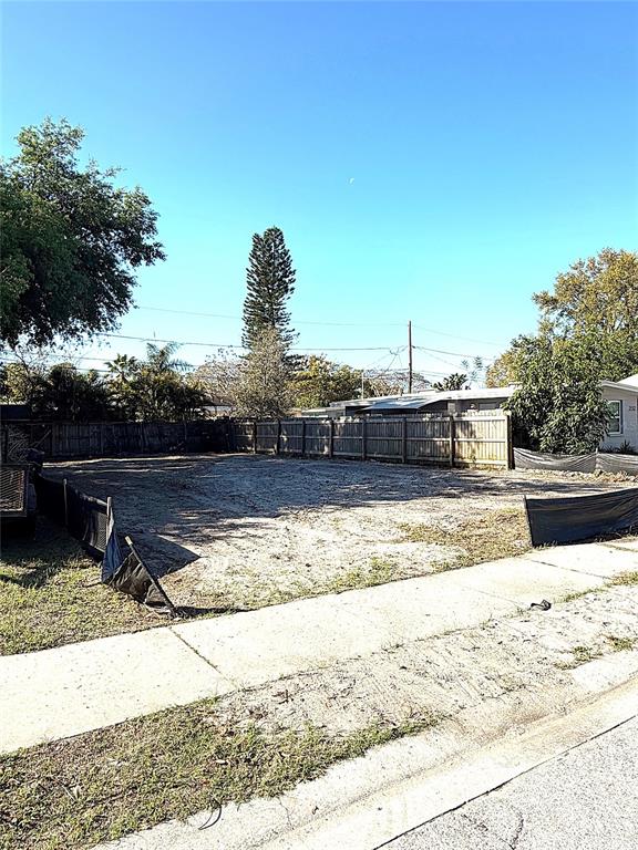 A vacant, cleared residential lot is enclosed by a wooden fence and black silt fencing — 2126 43RD AVENUE N, ST PETERSBURG, FL