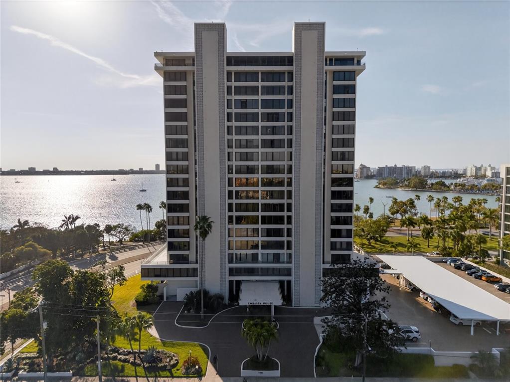 An aerial view shows a coastal road, palm trees, and high-rise buildings along the water — 770 S PALM AVENUE UNIT PH2, SARASOTA, FL