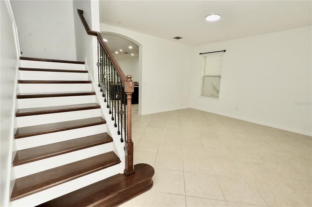 A kitchen features dark wood cabinets, granite countertops, stainless steel appliances, and a center island — 6526 GOLDEN DEWDROP TRAIL, WINDERMERE, FL