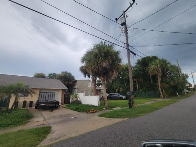 A residential street view showing a house with a driveway, trailer, and palm trees — 507 PHOENIX AVENUE, DAYTONA BEACH, FL