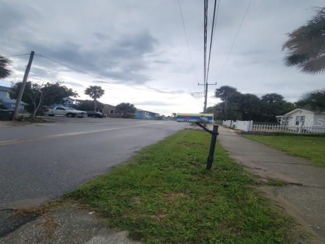 A street view showing a mailbox, a sidewalk, and houses under a cloudy sky — 507 PHOENIX AVENUE, DAYTONA BEACH, FL