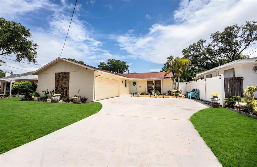 An aerial view shows a residential neighborhood with a house featuring a backyard swimming pool — 14803 SUNSET DRIVE, LARGO, FL
