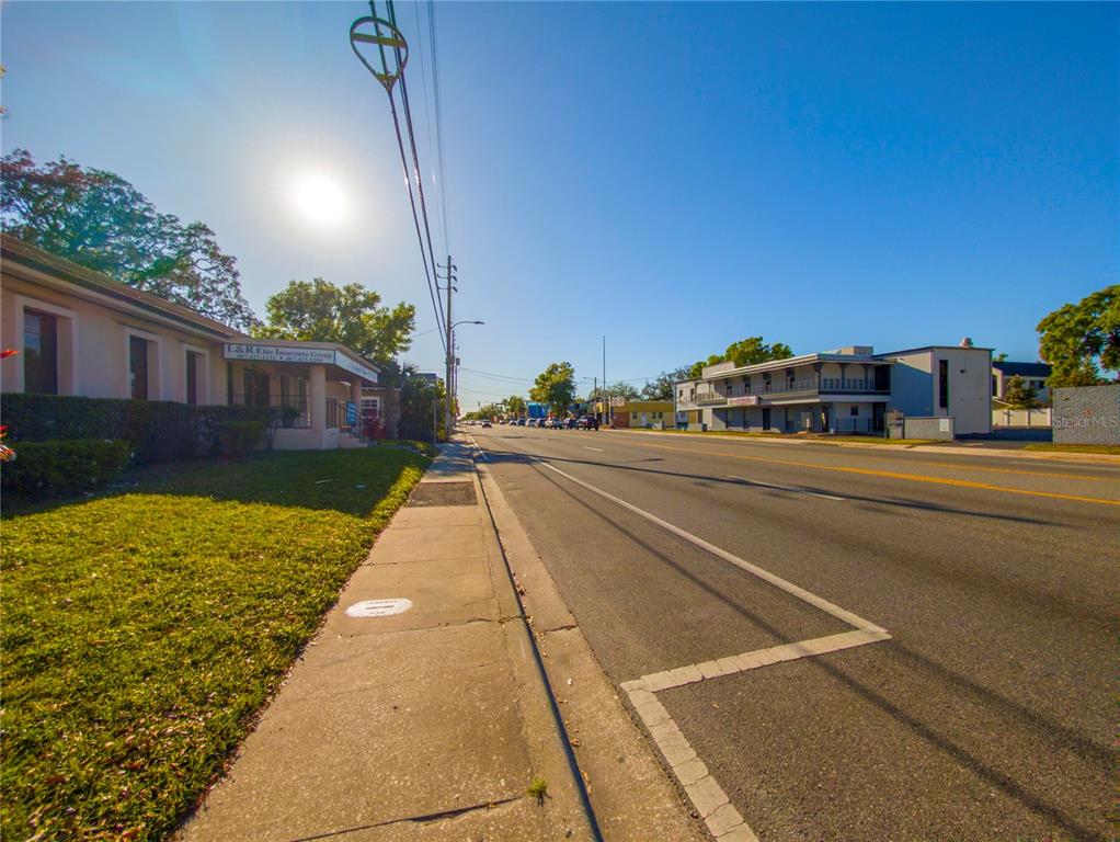 A sunny street view shows a sidewalk, a multi-lane road, and commercial buildings — 802 E COLONIAL DRIVE, ORLANDO, FL