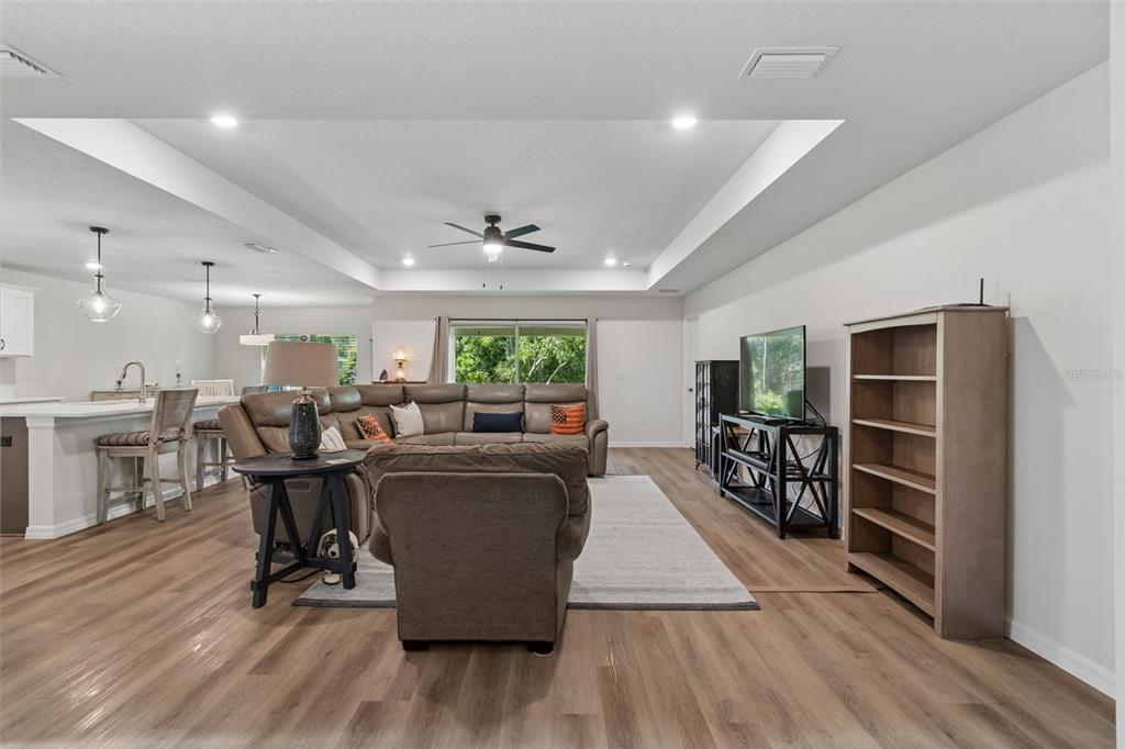 A view from an open front door into a hallway leading to a living room — 8948 CARRIE WAY, WEEKI WACHEE, FL