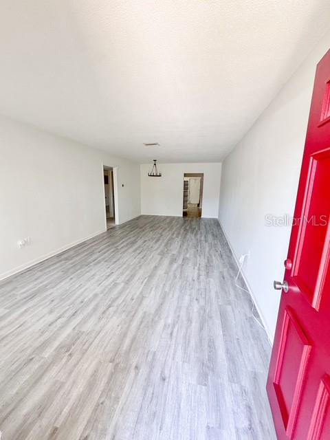 This dining room features beige carpet, a chandelier, and an open doorway to another room — 5860 38TH AVENUE N UNIT 29, ST PETERSBURG, FL