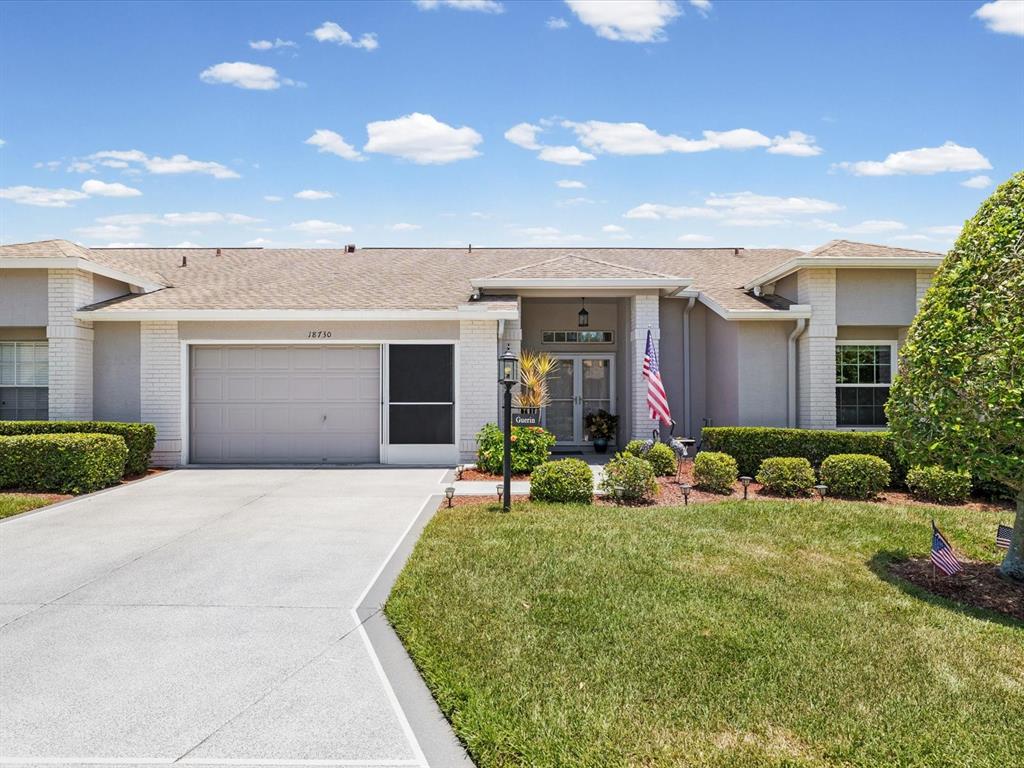 This is a floor plan of a single-story house with a garage and screened porch — 18730 WORTHINGTON DRIVE, HUDSON, FL