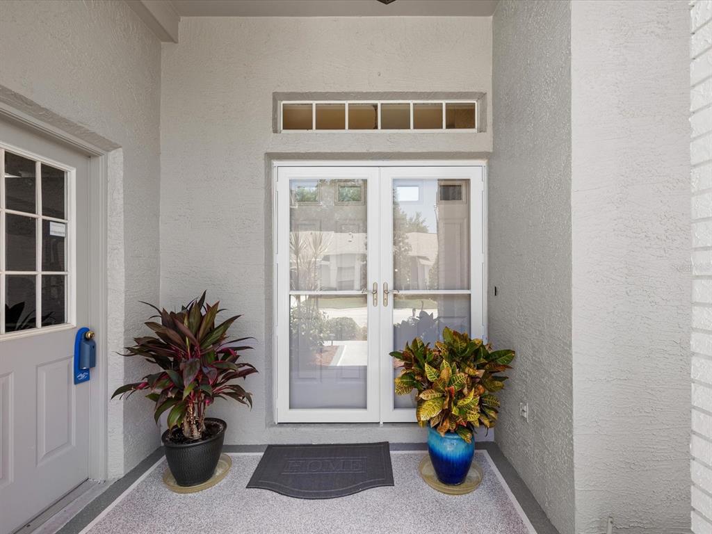 A single-story house with a beige exterior, a two-car garage, and a landscaped front yard — 18730 WORTHINGTON DRIVE, HUDSON, FL