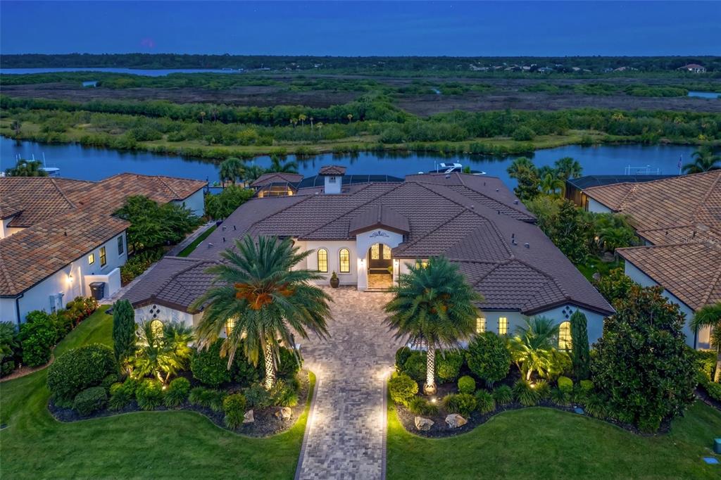 An aerial view of a large house with a tiled roof and a paved driveway — 11424 HARBOURSIDE LANE, PARRISH, FL
