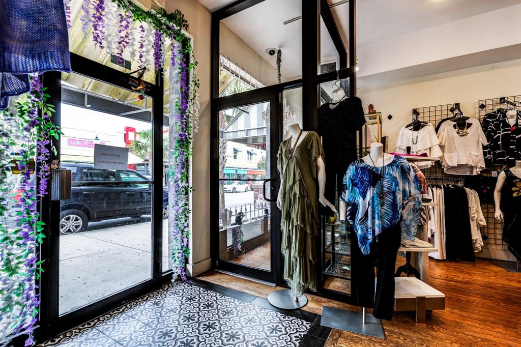 A retail clothing store interior features mannequins, patterned tile flooring, and a glass-paned entrance — 427 N DONNELLY STREET, MOUNT DORA, FL