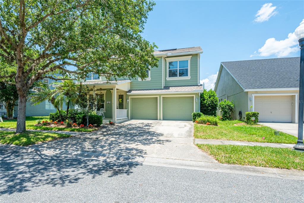 A two-story house with a two-car garage and a large tree in the front yard — 4930 ATWOOD DRIVE, ORLANDO, FL