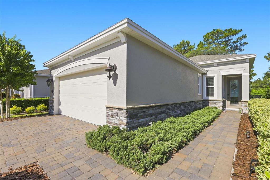 A bright entryway features a white front door, light wood-look flooring, and a metal shelf — 177 OLD MOSS CIRCLE, DELAND, FL