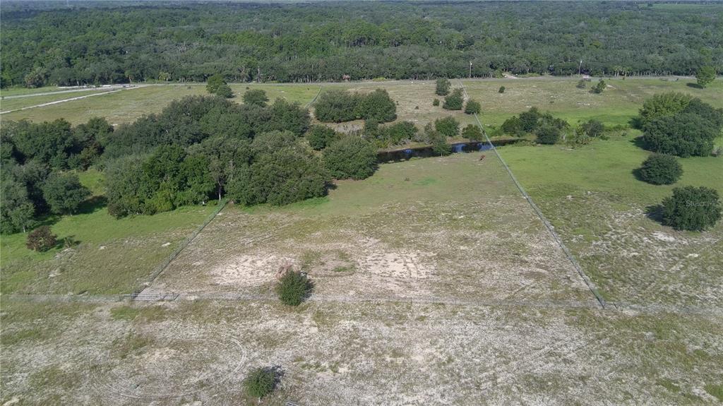 An aerial view shows a fenced, grassy rural lot with scattered trees and a small pond — 4547 GLEN SAINT MARY ROAD, LAKE WALES, FL