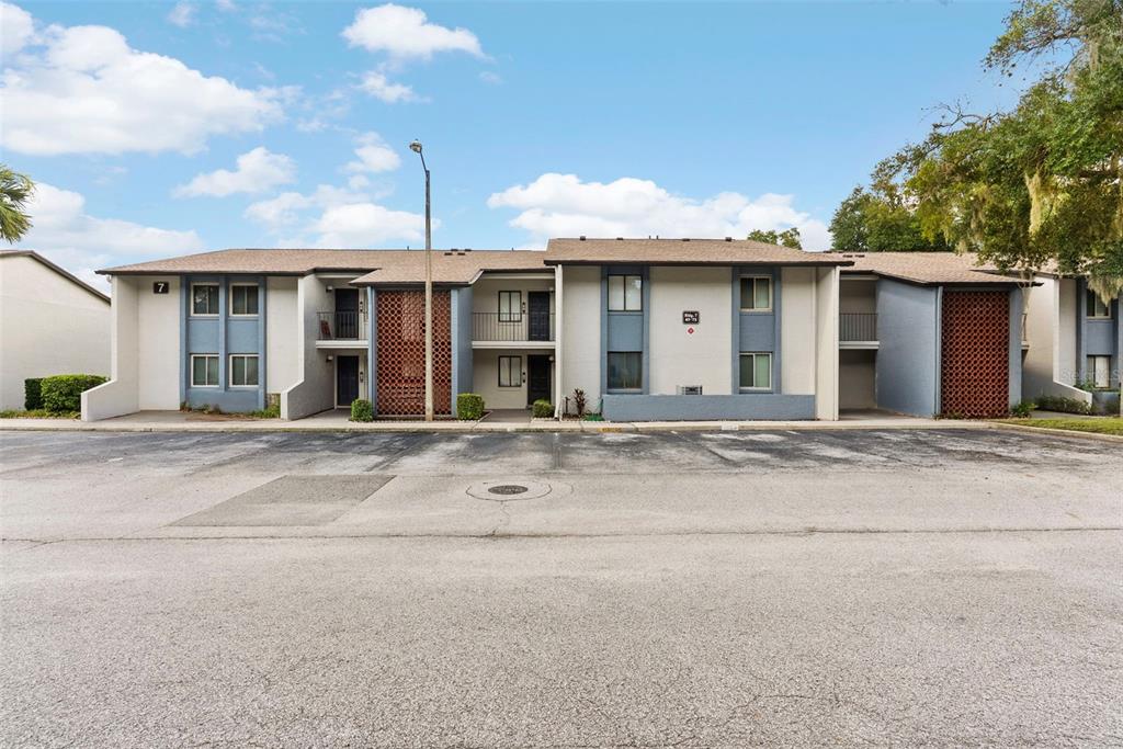 The exterior of a residential unit features a front door, a window, and a balcony — 7 ESCONDIDO CIRCLE UNIT 67, ALTAMONTE SPRINGS, FL