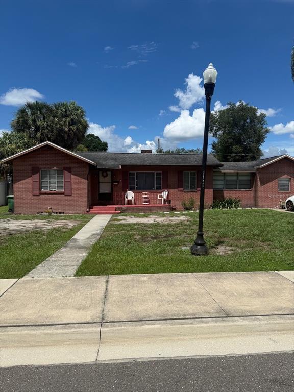 A restaurant exterior features a white brick facade with a dark brown entrance and patio — 1715 W CARMEN STREET, TAMPA, FL
