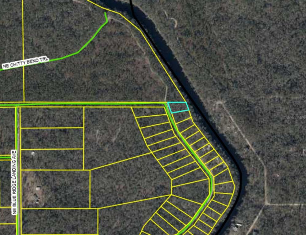 This is an aerial map showing a parcel of land highlighted in light blue — NE CHERVIL DRIVE, LEE, FL