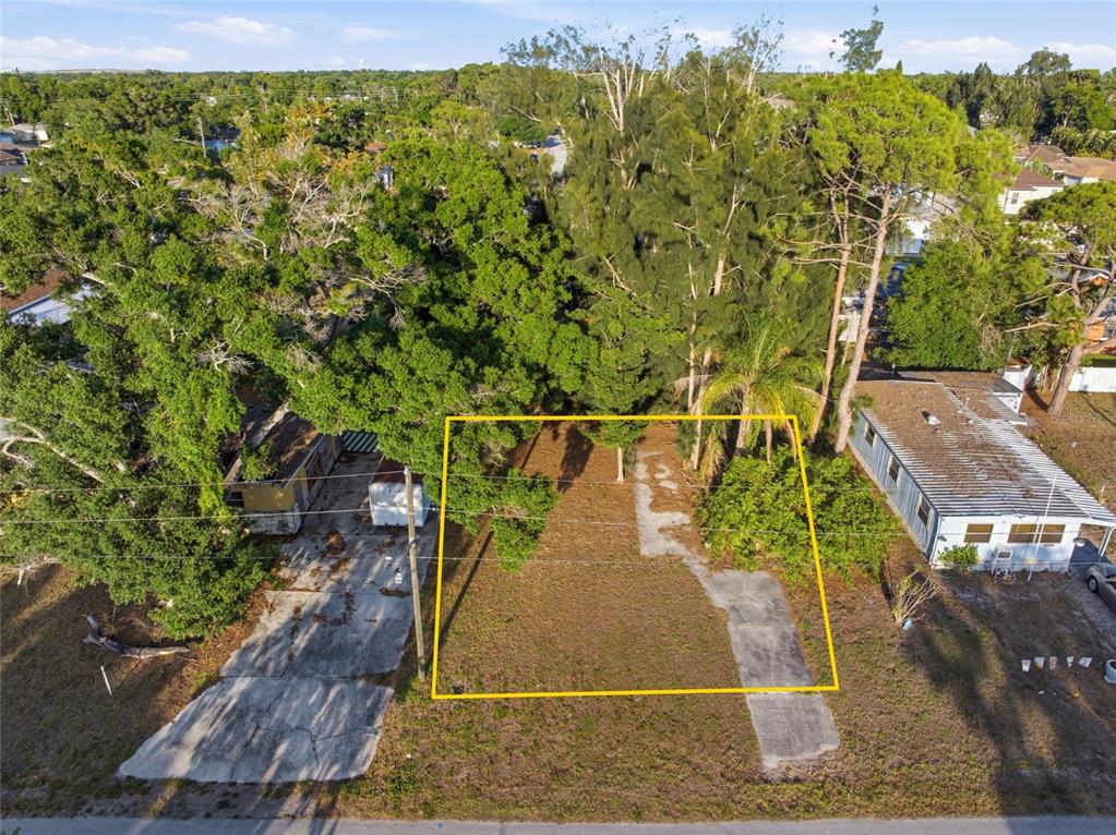 An aerial view shows a rectangular lot with a concrete slab and mature trees — 61ST LANE, PINELLAS PARK, FL