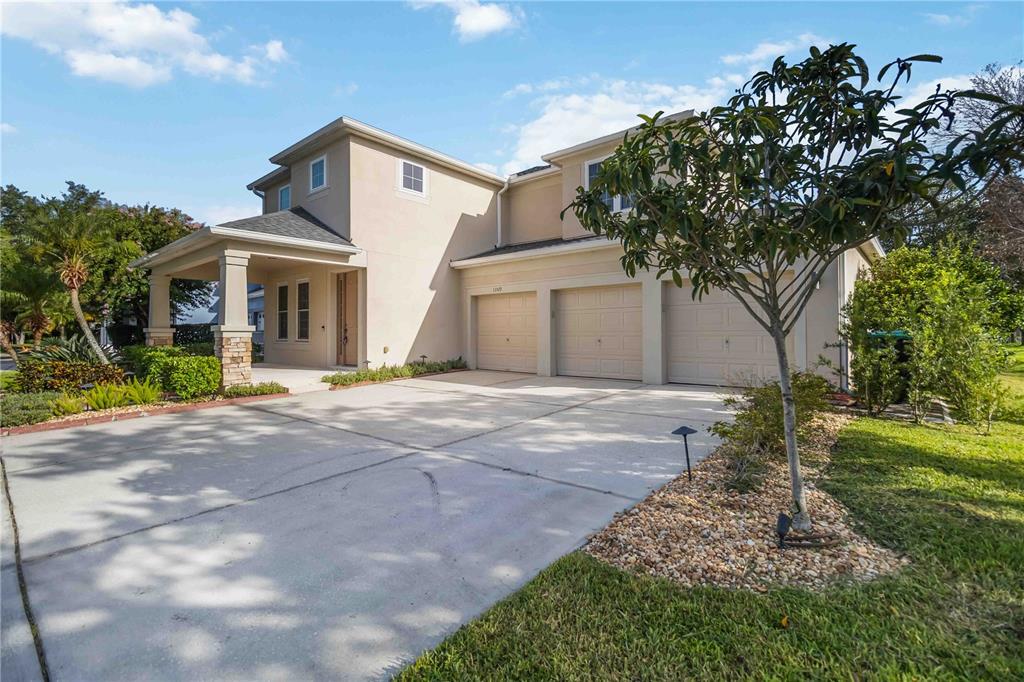 A two-story house with a three-car garage and a covered front porch — 13519 BICTON LANE, WINDERMERE, FL