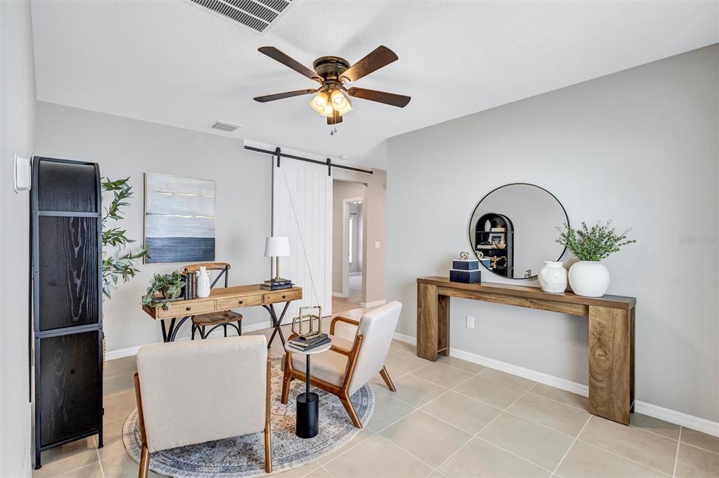 A home office features a wooden desk, two chairs, a console table, and a ceiling fan — 6255 SPRINGMONT LOOP, PALMETTO, FL
