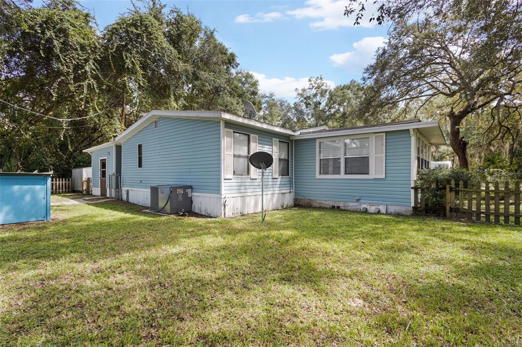 A light blue single-story house with white trim and a satellite dish in the yard — 11151 NW 112TH PLACE, CHIEFLAND, FL