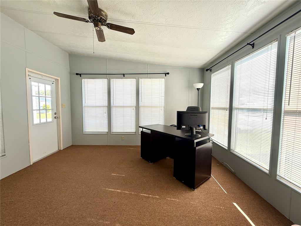 A dining room features a wooden table, chairs, a hutch, and tile flooring — 225 N SAINT THOMAS CIRCLE, APOLLO BEACH, FL