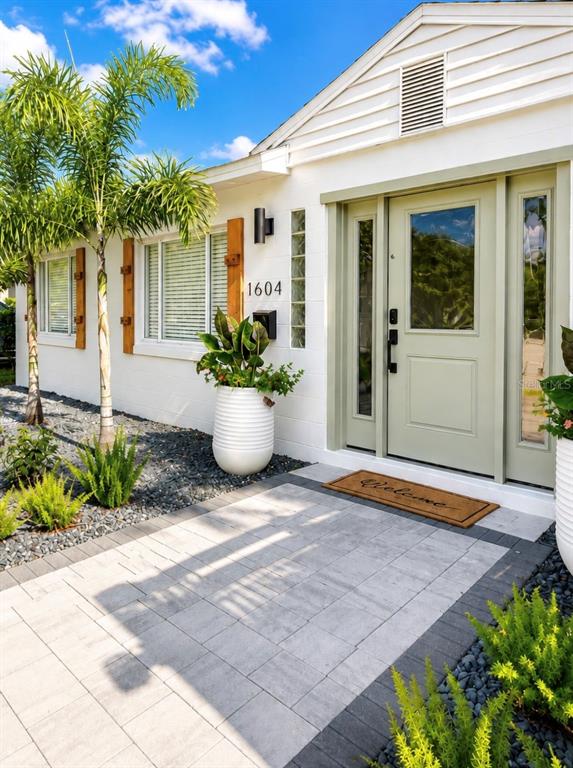 The exterior of a white house features a light green front door and a paved walkway — 1604 BRYN MAWR STREET, ORLANDO, FL