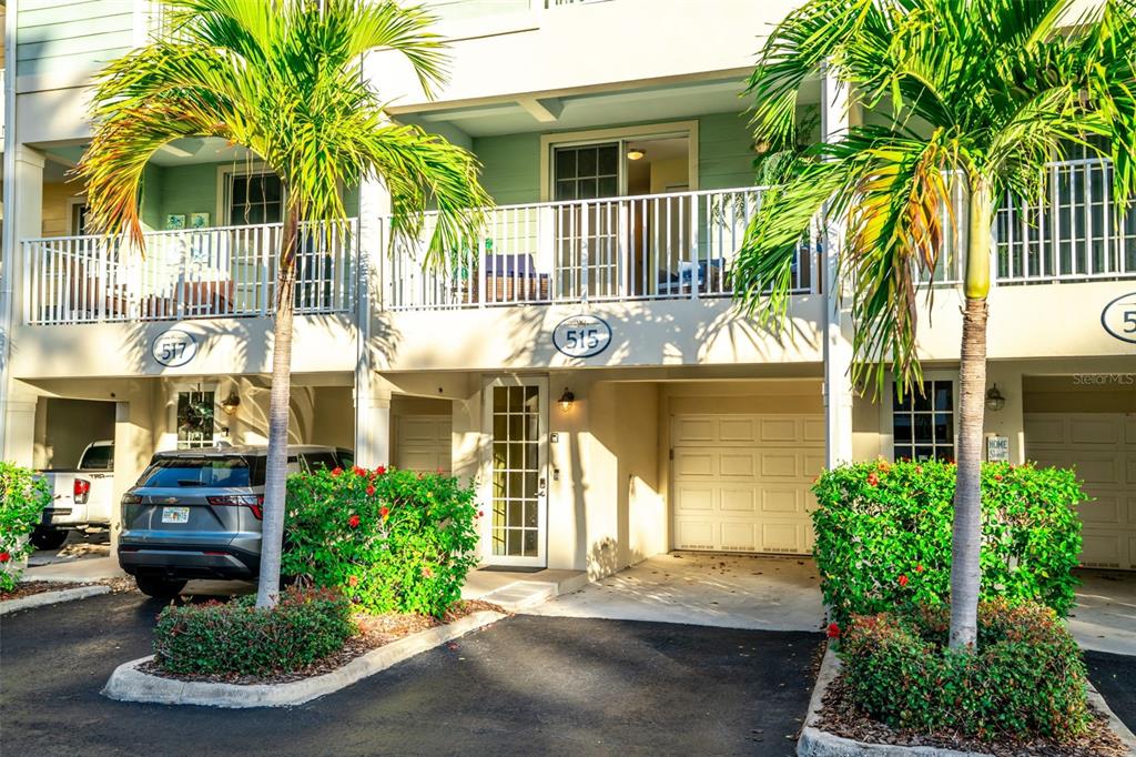 Exterior view of a two-story townhouse with a ground-level garage and a second-floor balcony — 515 BAHIA BEACH BOULEVARD, RUSKIN, FL