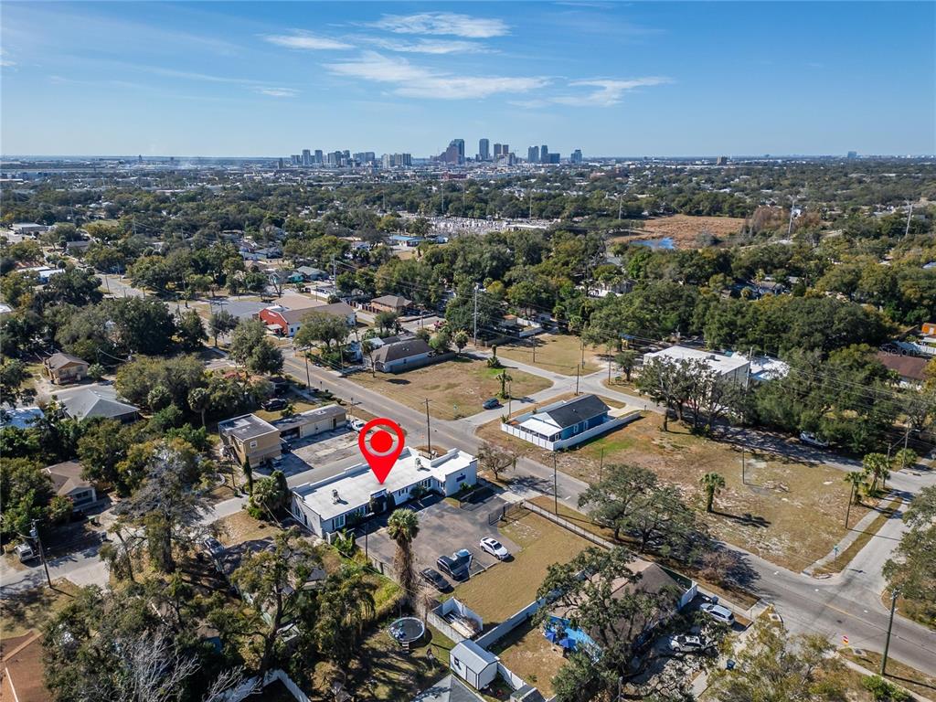 An aerial view shows a commercial building with a parking lot in a suburban area — 3411 N 29TH STREET, TAMPA, FL