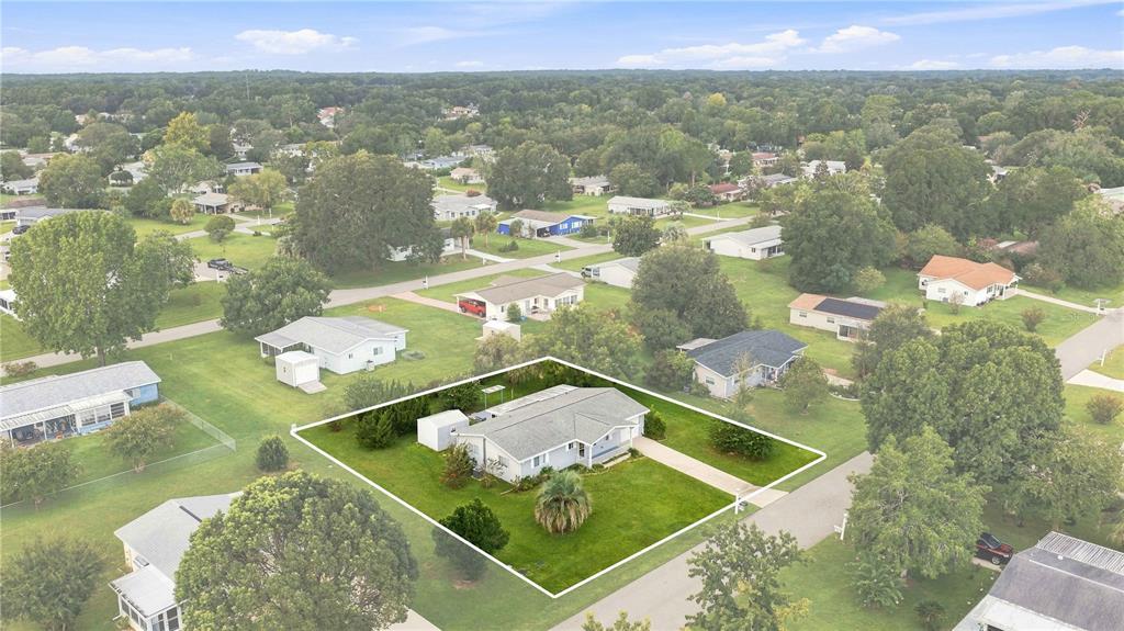 An aerial view shows a single-story house with a gray roof and lawn in a neighborhood — 6362 SW 106TH PLACE, OCALA, FL