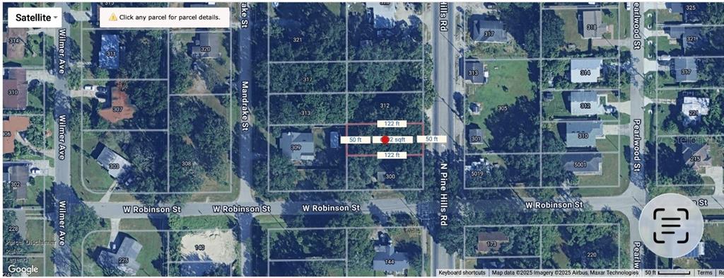This is a satellite map view showing a rectangular land parcel highlighted in red — 310 N PINE HILLS ROAD, ORLANDO, FL