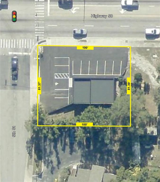 This is an aerial map showing a rectangular commercial property lot with a parking area — 516 E HIGHWAY 50, CLERMONT, FL