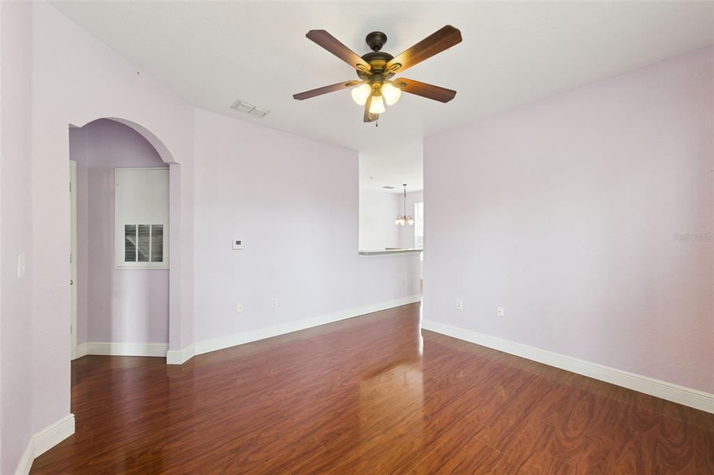 An empty room with light purple walls, dark wood flooring, and a ceiling fan — 832 GRAND REGENCY POINTE POINT UNIT 105, ALTAMONTE SPRINGS, FL