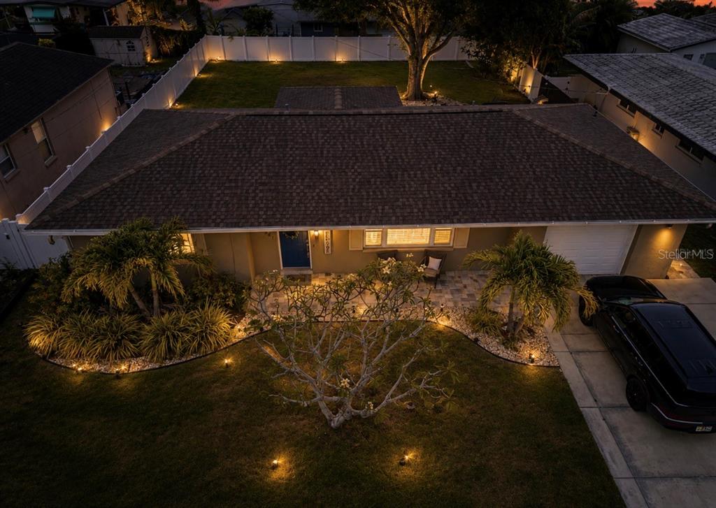 An aerial view shows a single-story house with a brown shingled roof and a driveway — 10541 86TH AVENUE, SEMINOLE, FL