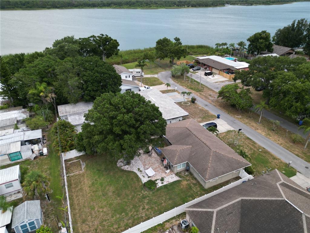 An aerial view shows a residential house with a backyard patio and large trees — 10541 86TH AVENUE, SEMINOLE, FL