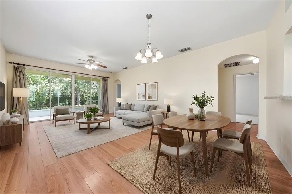 A single-story house with yellow siding, a white garage door, and a screened front entryway — 4962 RAINBOW TROUT ROAD, TAVARES, FL
