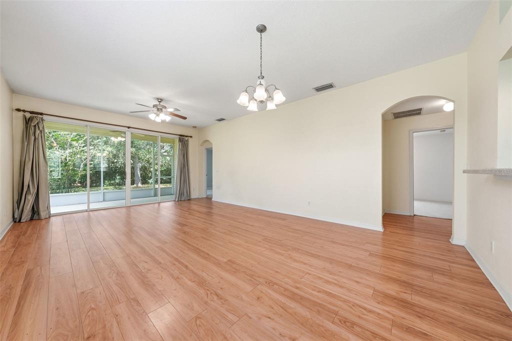 A single-story house with yellow siding, a two-car garage, and a concrete driveway — 4962 RAINBOW TROUT ROAD, TAVARES, FL