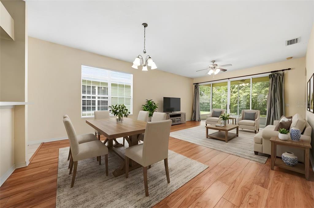 A concrete walkway leads to a screened-in front porch with light yellow siding — 4962 RAINBOW TROUT ROAD, TAVARES, FL