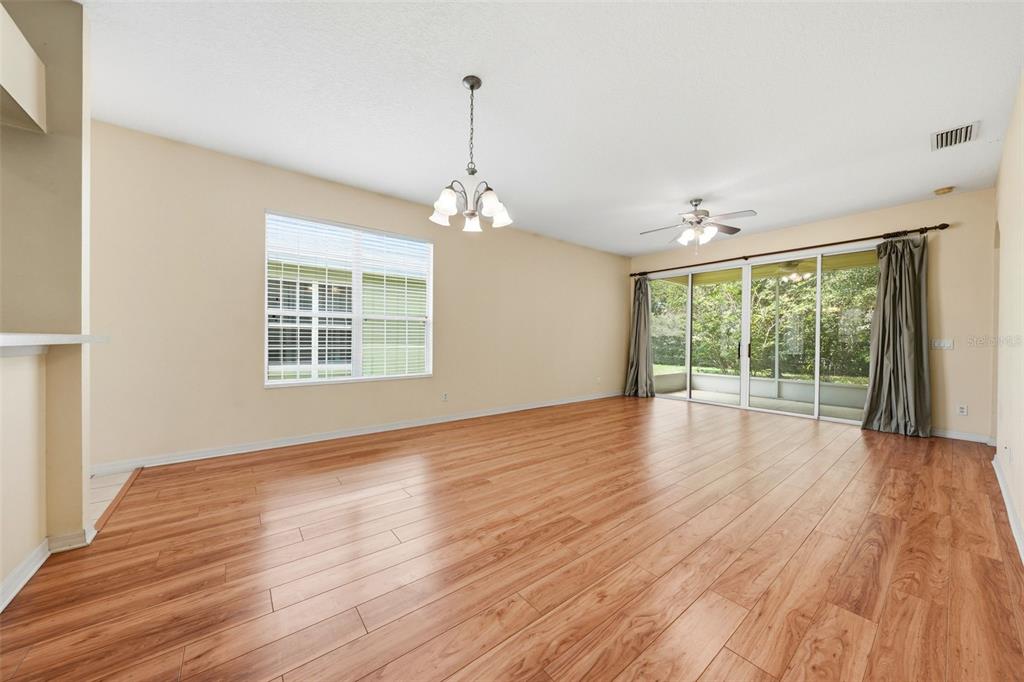 A covered entryway features a white front door with a glass insert and brick siding — 4962 RAINBOW TROUT ROAD, TAVARES, FL