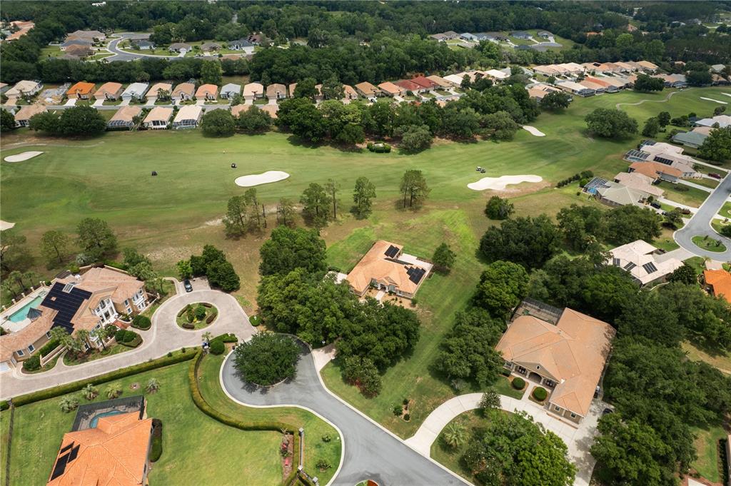 An aerial view shows several houses with tile roofs situated along a golf course — 1969 N YAWKEY POINT, HERNANDO, FL