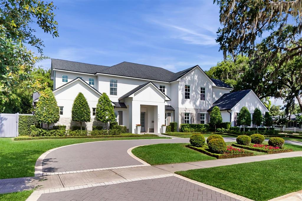 A two-story white house with a dark roof and a paved driveway in front — 1761 LEGION DRIVE, WINTER PARK, FL