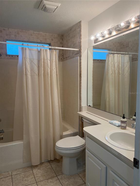 A kitchen with white cabinets, white appliances, and light-colored tile flooring — 6381 EGRET DRIVE UNIT 14, LAKELAND, FL