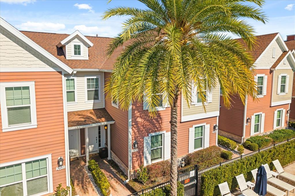An exterior view of a multi-story residential building with a palm tree in the foreground — 2637 SUNRISE SHORES DRIVE, KISSIMMEE, FL